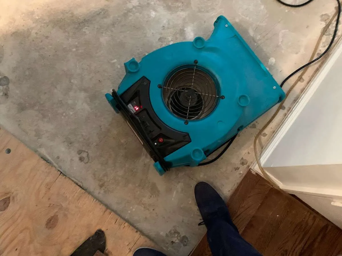 Air mover drying subfloor during Commercial Water Damage Restoration in Voorhees